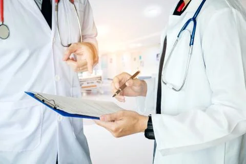 Two Doctor is talking about work in the hospital. Stock Photos