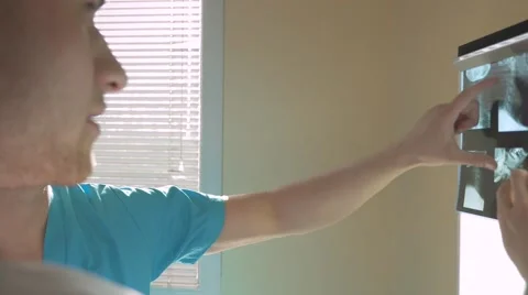 Two doctors are looking at their patient x-ray. Stock Footage 62948852