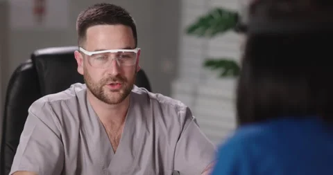 Two doctors are talking during a team meeting. Professional medical staff having Stock Footage 151605296