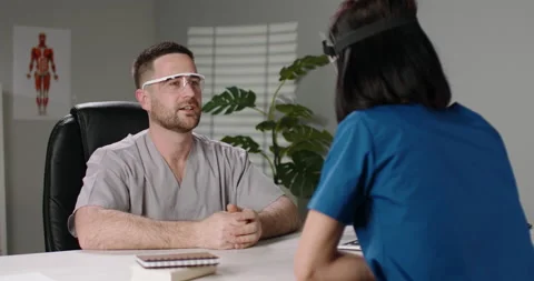 Two doctors are talking during a team meeting. Professional nurses and Stock Footage 155130795