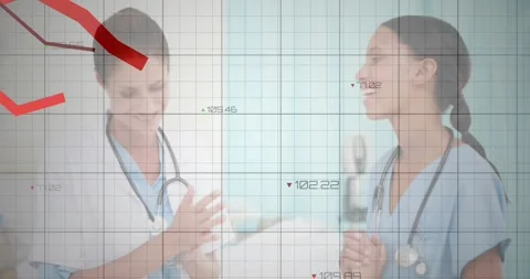 Two doctors comparing patient data in clinic, showing floating color?coded data Stock Footage 327849312