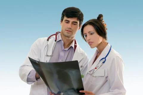 Two doctors conferring over x-ray results Stock Photos