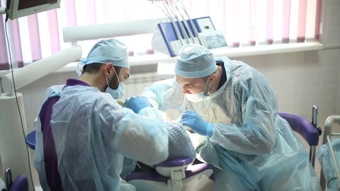 Two doctors dentists making surgery for tooth Stock Footage 111711859