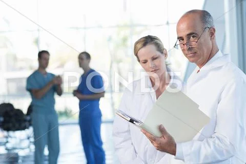 Two Doctors Discussing Medical Records