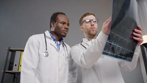 Two doctors discussing patients test results on x-ray Video stock 276222002