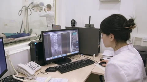 Two doctors examinting patient using xray machine Stock Footage 62347932