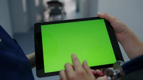 Two doctors hold a tablet with a green screen in the hospital corridor Stock Footage 206412928