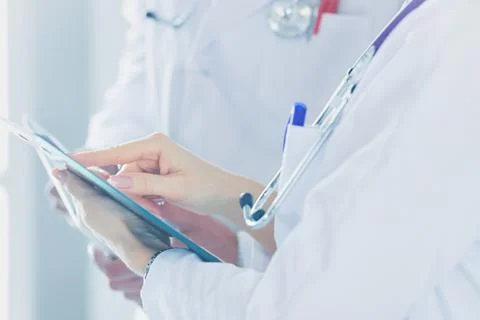 Two doctors holding a folder and talking about patient Stock Photos