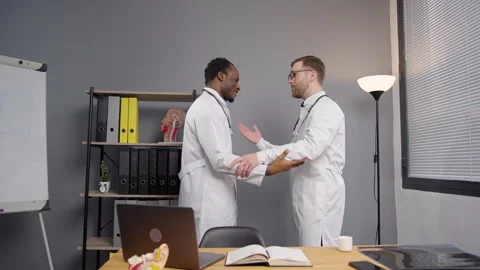 Two doctors in Lab Coat hug each other 스톡 동영상 264986054