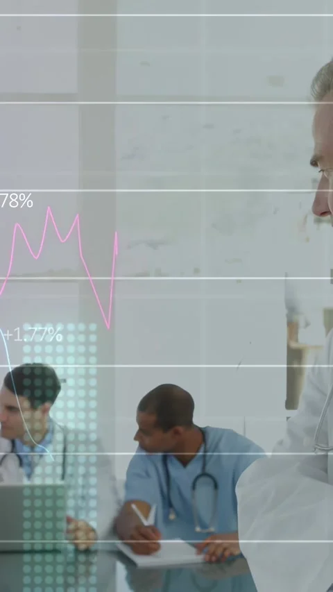 Two doctors leaning in after data charts appearing, checking laptop, noting, Stock Footage 331077469