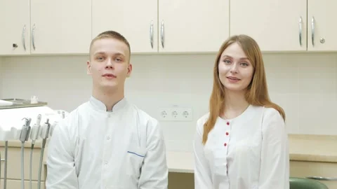 Two doctors look into camera, smile, thumbs up, greetings and video message, say Stock Footage 170416404