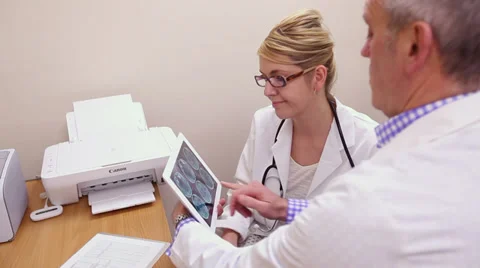 Two Doctors looking at brain scans Stock Footage 35133950