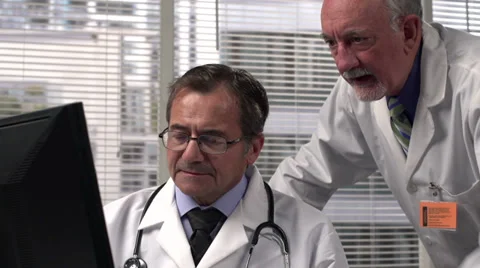 Two doctors looking at a computer screen - medium shot Stock Footage 32660842