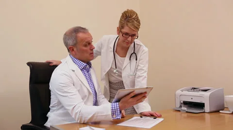 Two doctors looking at iPad Video stock 35066094