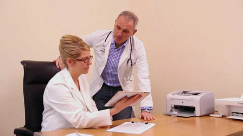 Two doctors looking at iPad Video stock 35104880