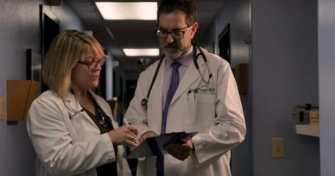 Two doctors looking at the same clipboard consulting and sharing ideas Stock-Footage 102349304