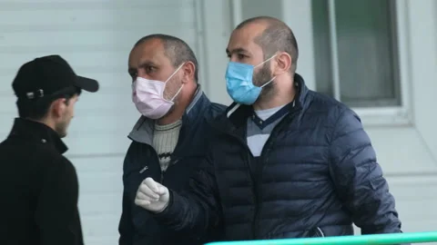 Two doctors in masks walking in gloves corona virus. People discussing covid-19. Stock Footage 130741619