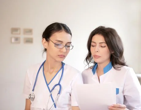 Two doctors with paper documents Stock Photos