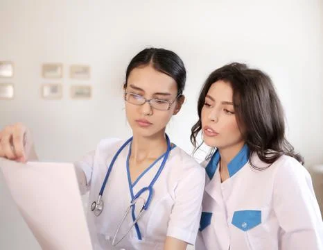 Two doctors with paper documents Stock Photos