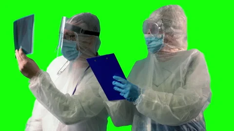 Two doctors in PPE suit uniforms, wearing medical protective mask and face Stock Footage 148292052