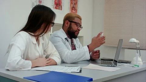 Two doctors prescribing pills through webcam 動画素材 71767816