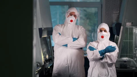 Two doctors in protective suits, respirators and safety glasses. Stock Footage 314342216