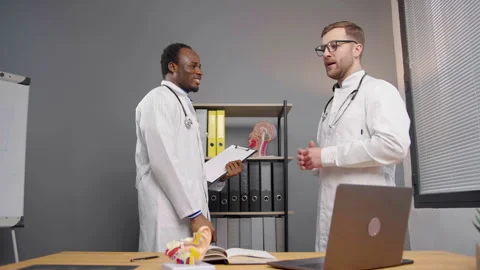 Two Doctors Shake Hands at office of medical clinic Stock Footage 264980159