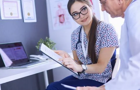 Two doctors speaking in a bright office Stock Photos