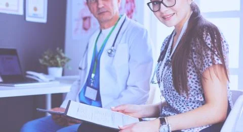 Two doctors speaking in a bright office Stock Photos