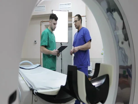 Two doctors in surgical suits discussing the history of the patient Stock Footage 73094902