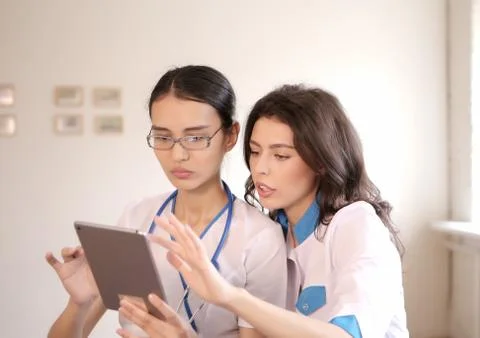 Two doctors with tablet computer Stock Photos