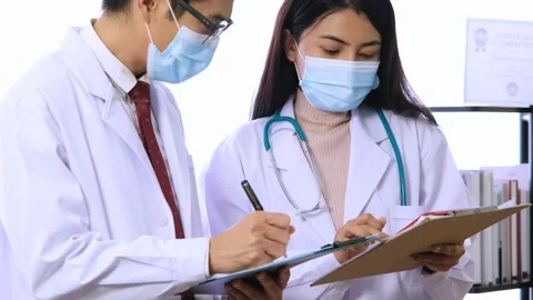 Two doctors talking about patient's test results. Stock Footage 133572646