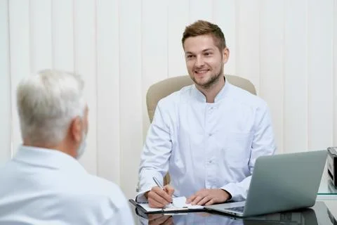 Two doctors talking and discuss treatment. Stock Photos
