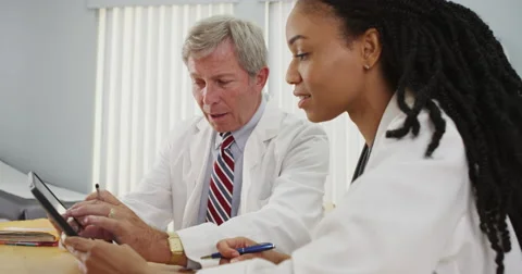 Two doctors using tablet in the office Stock Footage 58353419