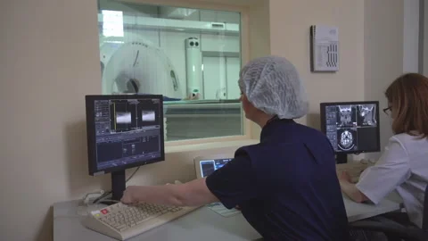 Two Doctors Watching The Obtaining Data From Ct And Mri Scanners (On Dolly) Stock Footage 107490853