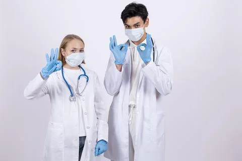 Two doctors in white coats wearing medical masks Stock Photos