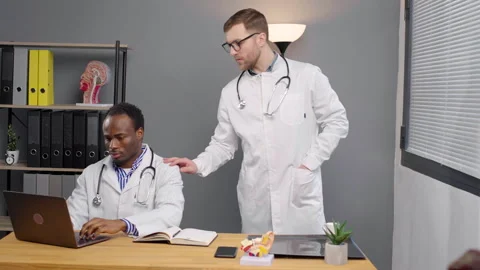 Two doctors in White Lab Coats at office in medical clinic Stock Footage 264985746