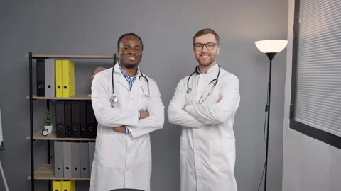 Two doctors in White Lab Coats Together at medical clinic 動画素材 264986004