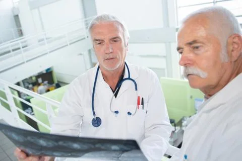 Two doctors with xray on white Stock Photos