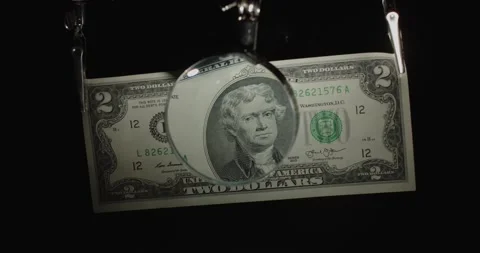 Two-dollar US banknote. 2 cash through a magnifying glass. 2 bucks on black Stock Footage 168988941