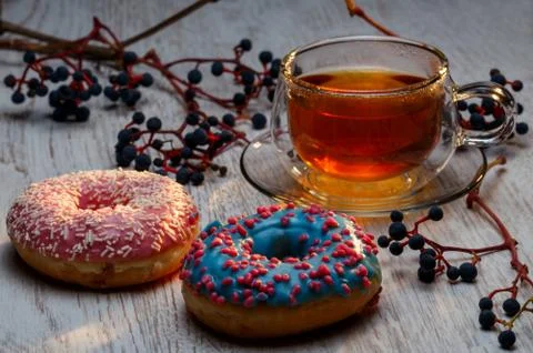 Two donuts and a cup of tea Stock Photos