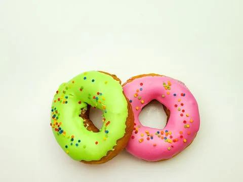 Two donuts for Breakfast on isolated white background Stock Photos