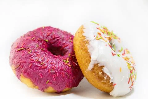 Two donuts covered with a red glaze top view on a white background Stock Photos