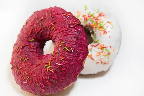Two donuts covered with red glaze top view on white background Stock Photos