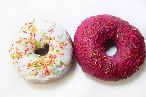 Two donuts covered with a red glaze top view on a white background Stock Photos