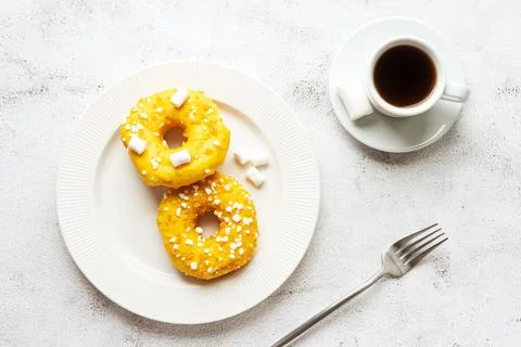 Two donuts with marshmallows and a cup of coffee Stock Photos