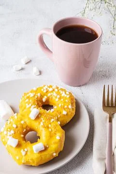Two donuts with marshmallows and a cup of tea or coffee Stock Photos