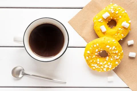Two donuts with marshmallows and a cup of coffee Stock Photos