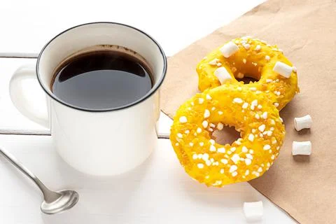Two donuts with marshmallows and a cup of coffee Stock Photos
