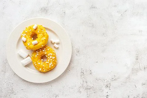 Two donuts with marshmallows served on a plate Stock-Fotos